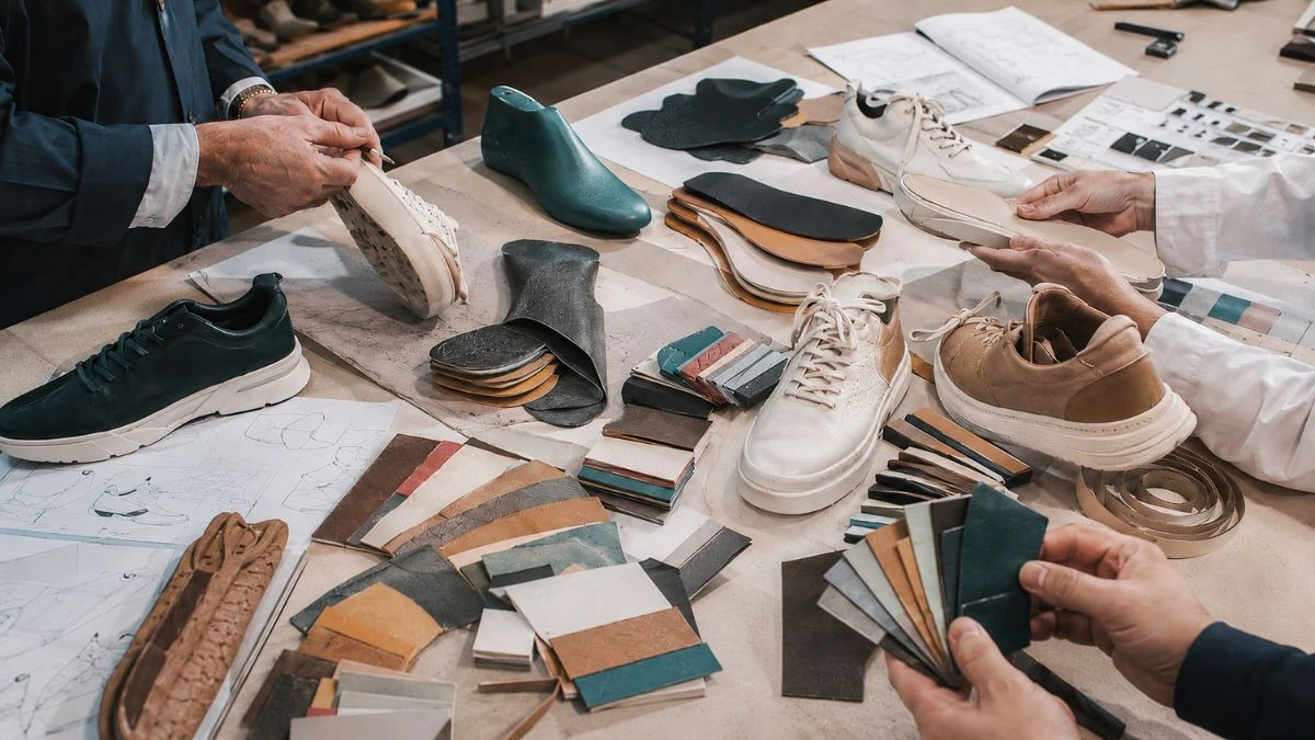 Footwear design and development process with prototypes, material selection, shoe components and product development planning inside a Portuguese shoe factory
